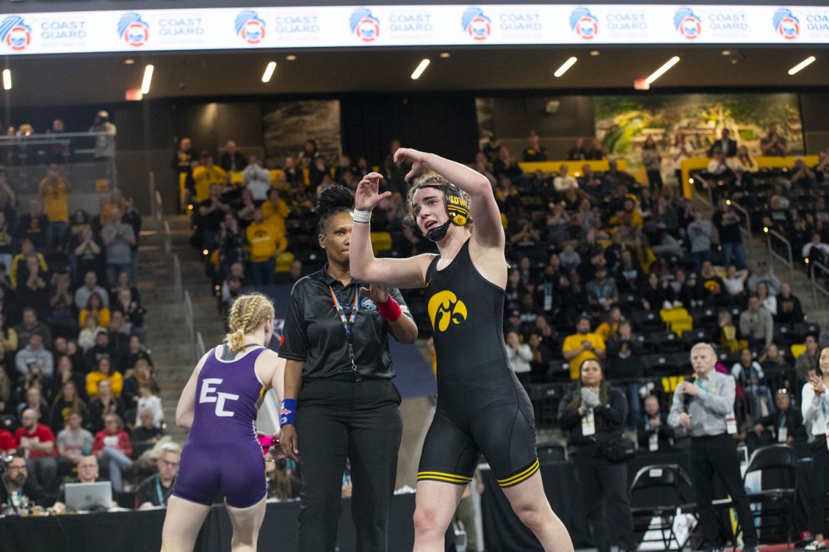Iowa 145-pound No. 2 Reese Larramendy makes a heart at fans during session three of the National College Women’s Wrestling Championship at Xtream Arena in Coralville on Saturday, March 8, 2025. The Hawkeyes scored 201.5 team points, securing their second consecutive NCWWC National Championship.