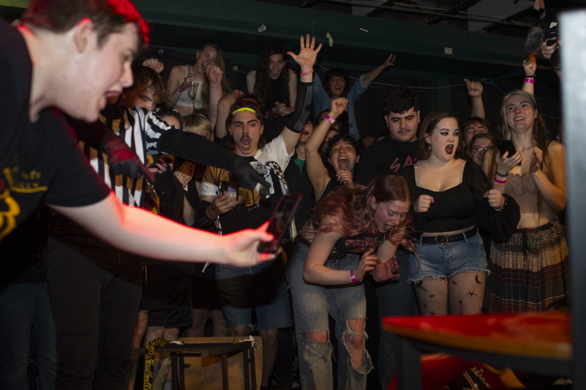 Attendees cheer during an underground pro-wrestling event at Gabe's in Iowa City on Friday, March 14, 2025. The event featured four matchups between pro-wrestlers from the Black and Brave Wrestling Academy based out of Davenport, Iowa.
