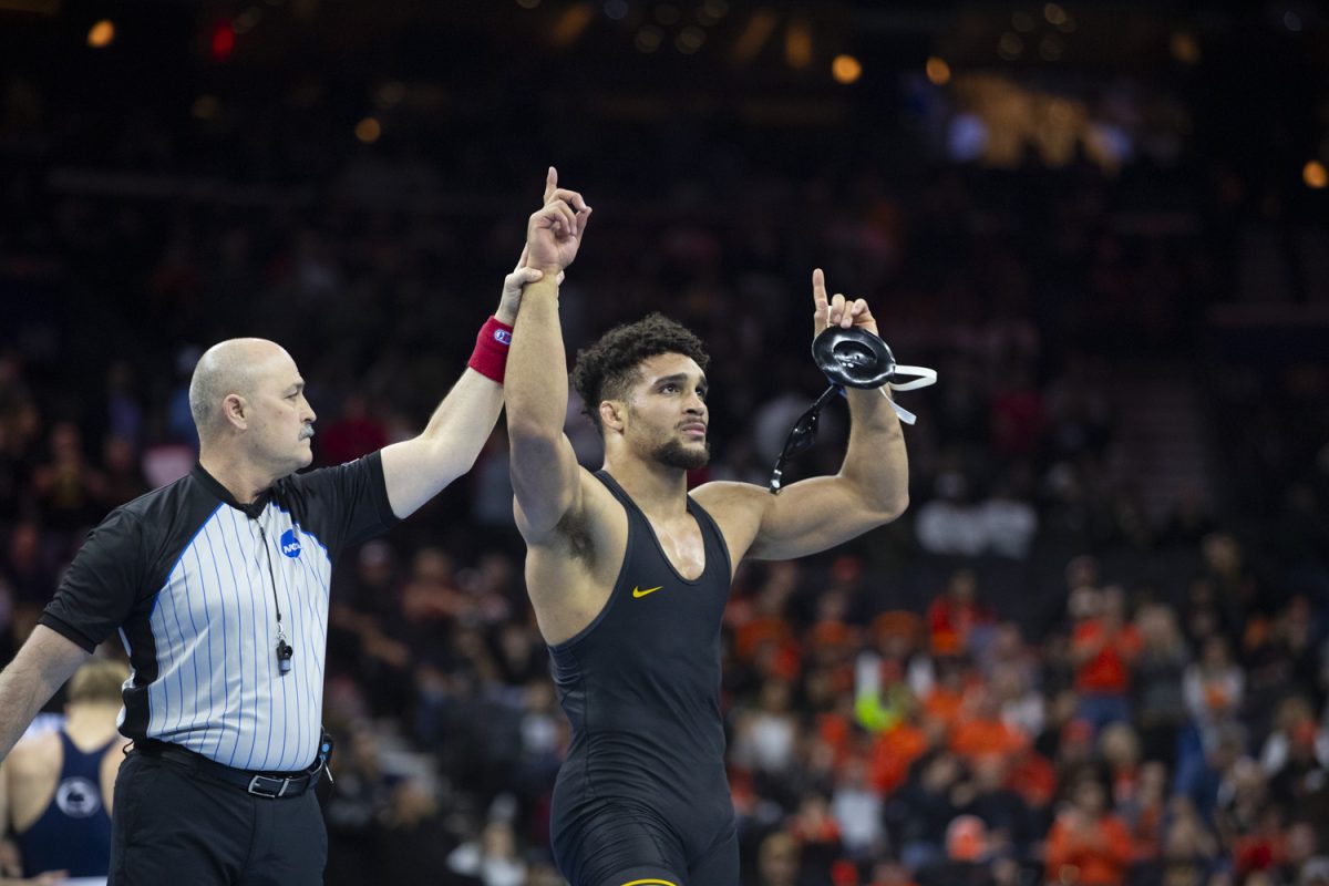 A referee holds up Iowa No. 2 197-pound Stephen Buchanans hand after defeating Penn State No. 4 Josh Barr during finals of the NCAA Men's Wrestling Championship at Wells Fargo Center in Philadelphia, PA on Saturday, March. 22, 2025. Buchanan defeated Barr 5-2, crowning Buchanan as a NCAA Champion.