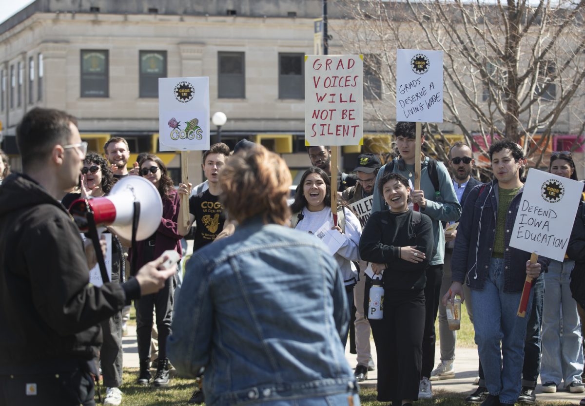 Protestors cheer during a COGS protest on the University of Iowa campus in Iowa City on Wednesday, March 26.