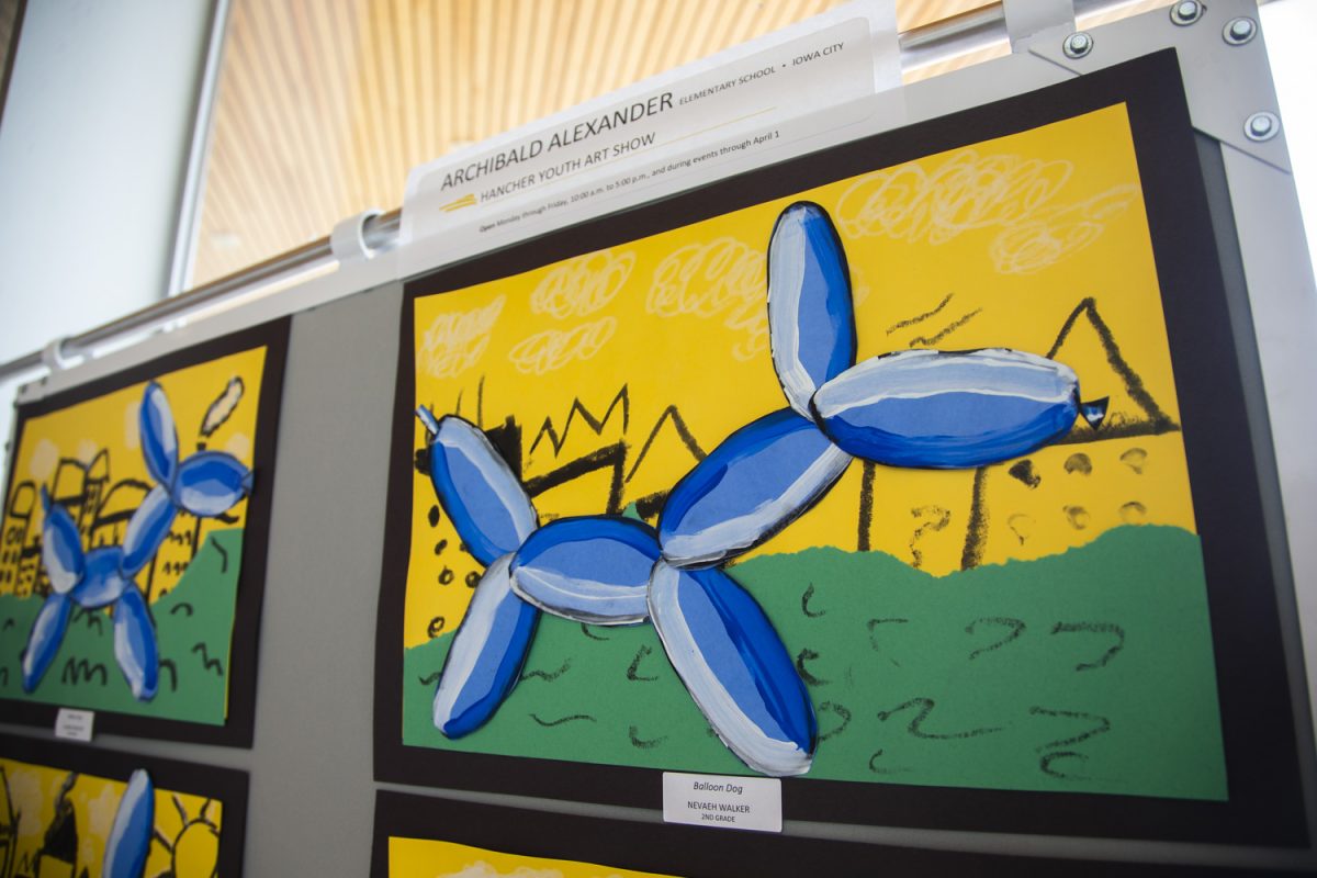 Artwork by Iowa City and adjacent area elementary through high school students stands on display inside the Hancher lobby on Wednesday, March 26, 2025.