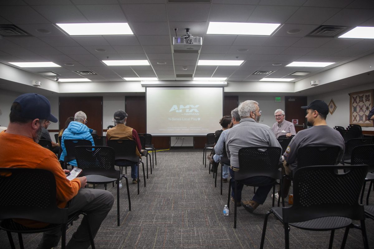 Attendees file in before the launch meeting of the Johnson County Solar Task Force inside of the Coralville Public Library on Thursday, March 27, 2025. The meeting began at 4pm and included panelists Chris Hoffman, Emily Zimmon, and Ed Williams.