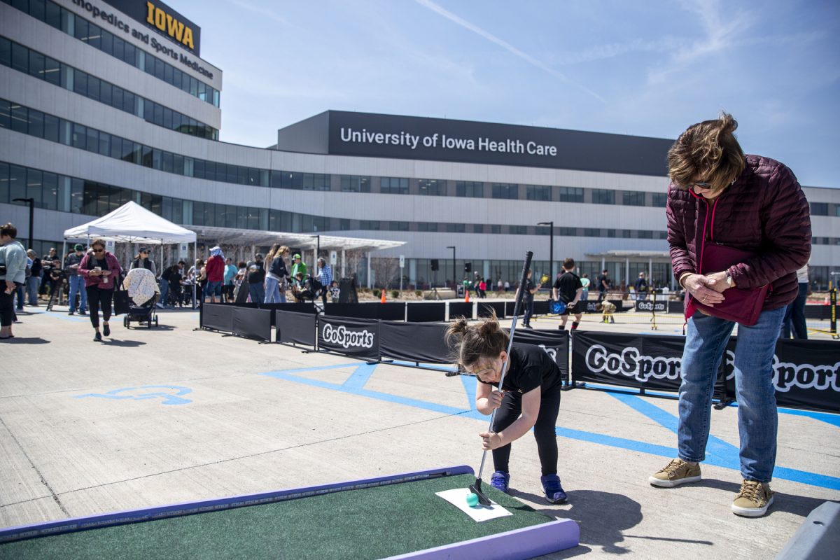 Chloe (3) prepares to hit a golf ball during a North Liberty Campus Community Open House in North Liberty, Iowa on Saturday, April 12, 2025. The hospital was budgeted for $526.6 million and is officially opening April 28. 