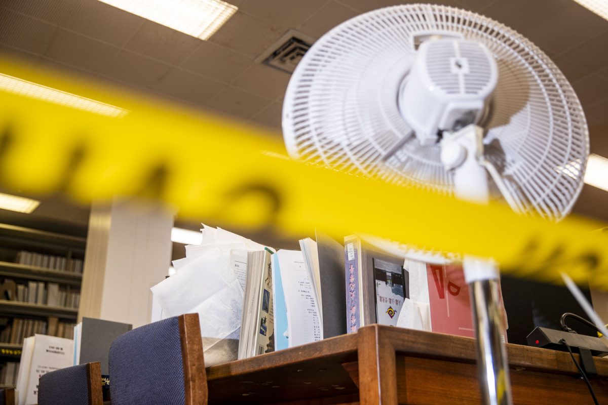 A fan blows on academic texts and other literature in the East Asian text collection are seen in the University of Iowa Main Library in Iowa City on Monday, April 14, 2025. A pipe burst in an office of the library, effectively leaking water across multiple floors. Damage is uncertain and expected to be minimal, but many documents were moved or set out to dry throughout the day and into Tuesday morning. Cleaning is ongoing, and the Reading Room will reopen on Monday. 