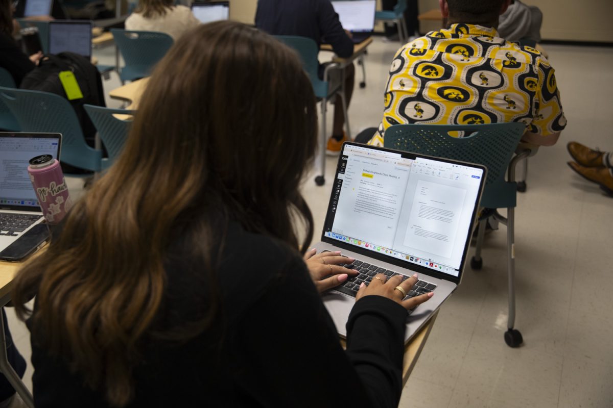 A student takes notes on a client meeting presentation in the English-Philosophy Building on April 29, 2025. 