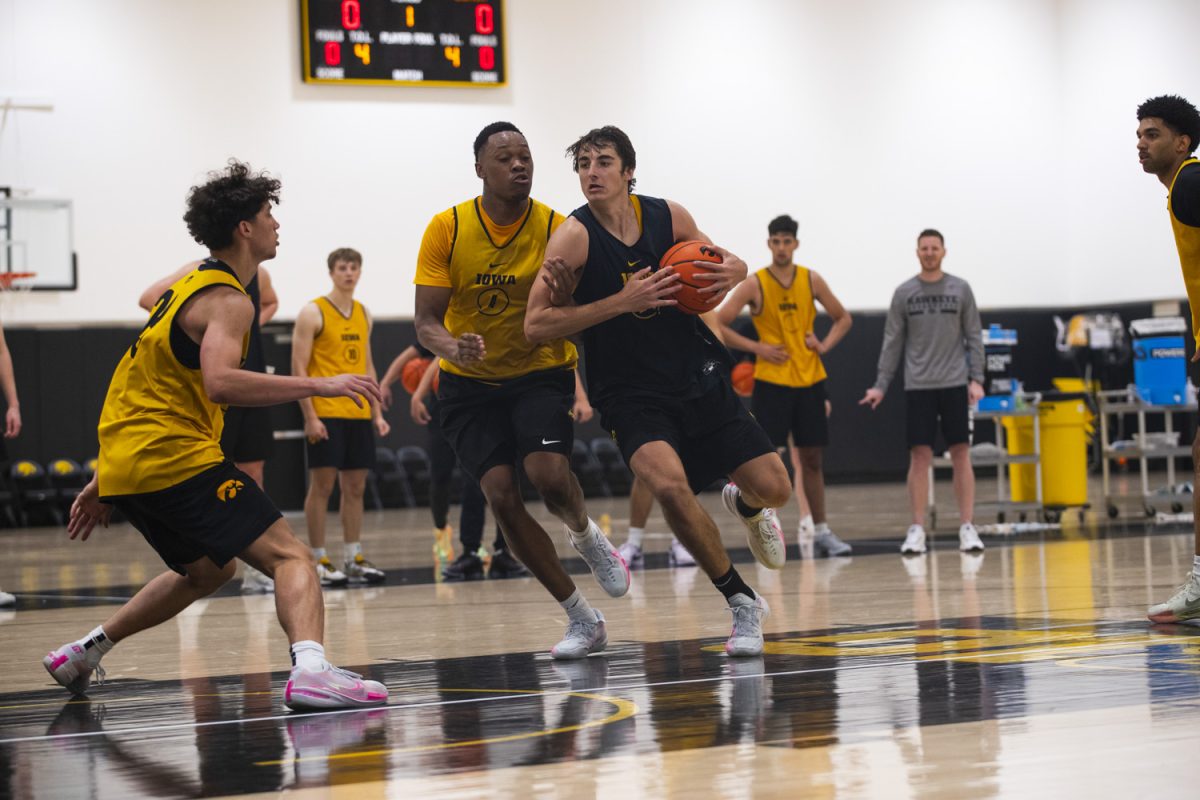 Tate Sage drives the ball during an Iowa mens basketball practice at Carver-Hawkeye Arena on Thursday June 19, 2025.
