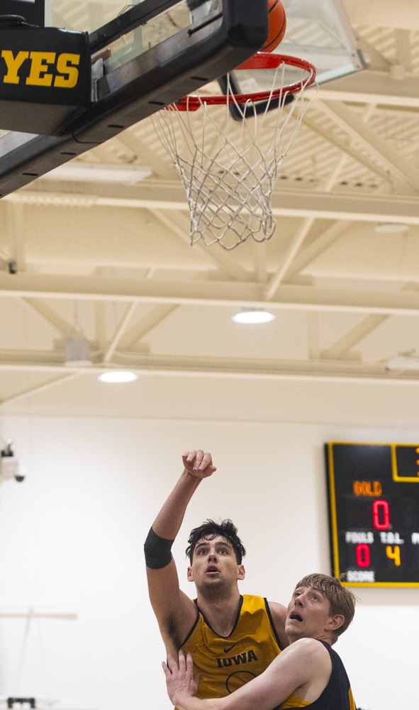 Joey Matteoni follows through as Cooper Koch plays defense during an Iowa mens basketball practice at Carver-Hawkeye Arena on Thursday June 19, 2025.