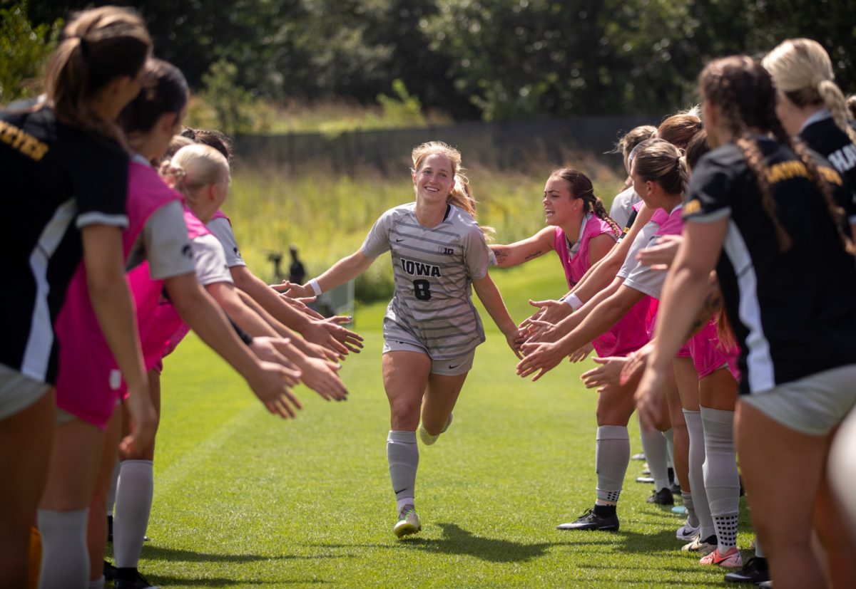 Price Loposer high fives teammates before taking the field in the match up between the No. 9 ranked Iowa Hawkeyes and the Western Michigan Broncos at the University of Iowa Soccer Complex in Iowa City, Iowa on Sunday, Aug. 24, 2025. The Hawkeyes defeated the Broncos 2-0.