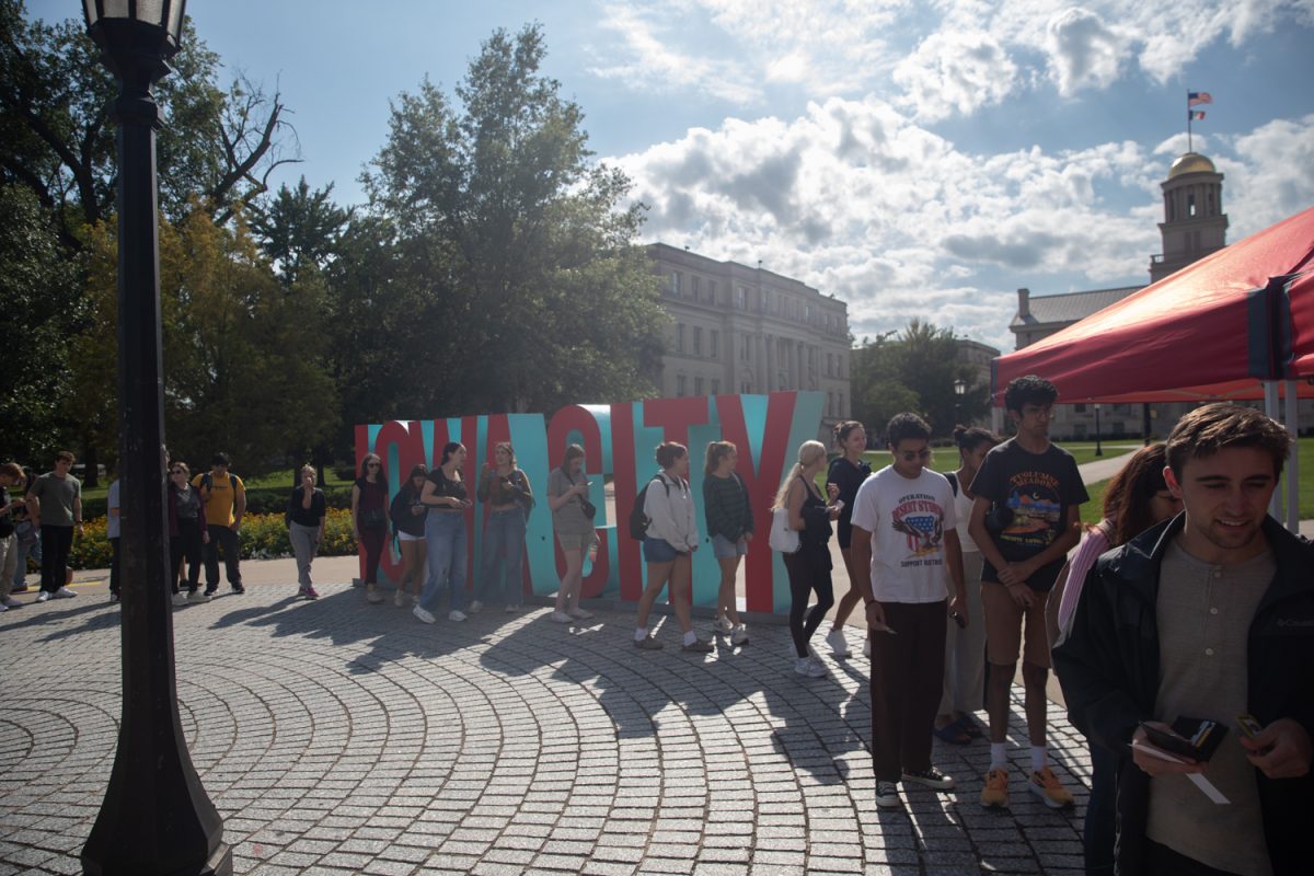 Students gather in the ticket line at the Taste of Iowa City event on Wednesday, Aug. 27, 2025. The free tickets were sold out after an hour, with over a hundred students and community members exchanging tickets for meals at restaurant stands downtown.
