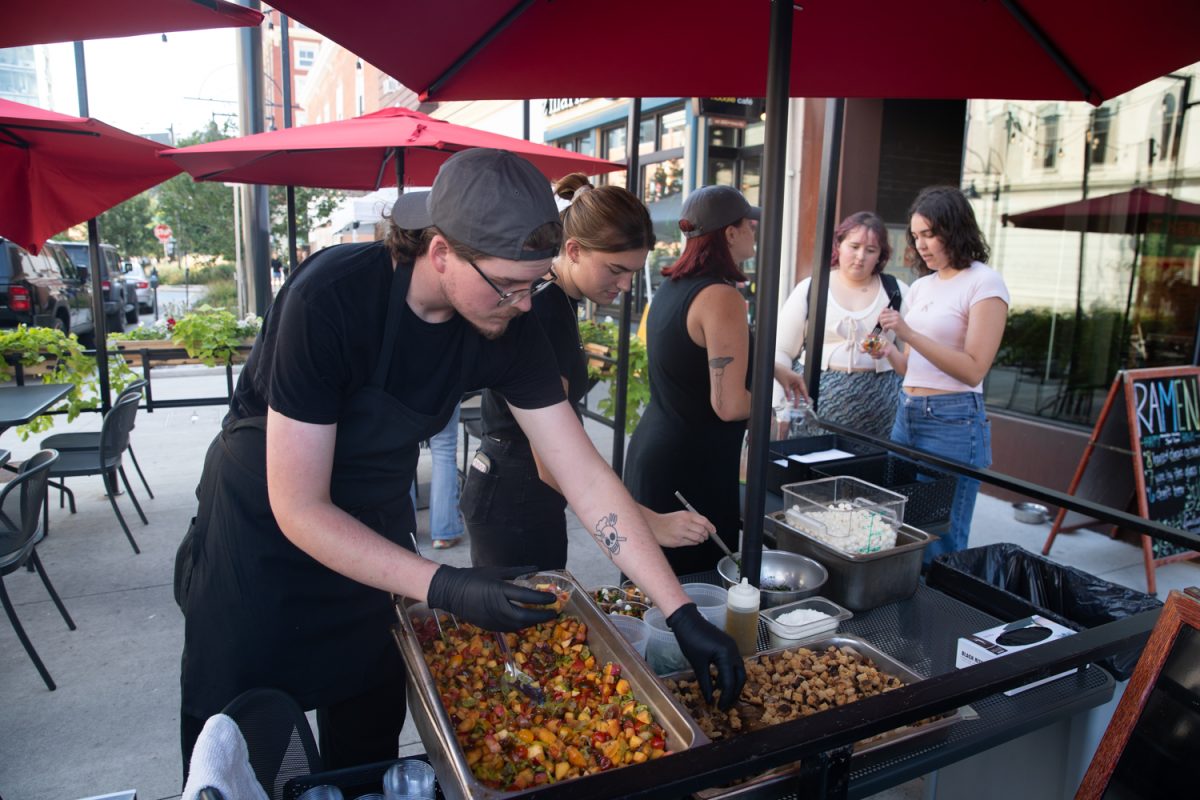 Servers make food for customers at the Taste of Iowa City event on Wednesday, Aug. 27, 2025. The free tickets were sold out after an hour, with over a hundred students and community members exchanging tickets for meals at restaurant stands downtown.