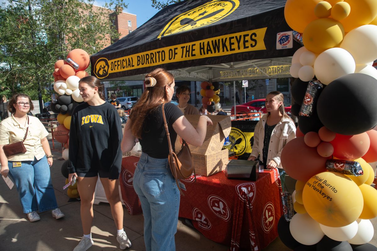 Customers line up for the Pancheros stand at the Taste of Iowa City event on Wednesday, Aug. 27, 2025. The free tickets were sold out after an hour, with over a hundred students and community members exchanging tickets for meals at restaurant stands downtown.