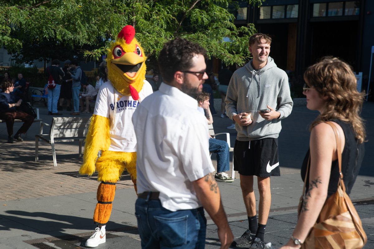 A chicken mascot for Brothers Bar &amp; Grill wanders downtown at the Taste of Iowa City event on Wednesday, Aug. 27, 2025. The free tickets were sold out after an hour, with over a hundred students and community members exchanging tickets for meals at restaurant stands downtown.