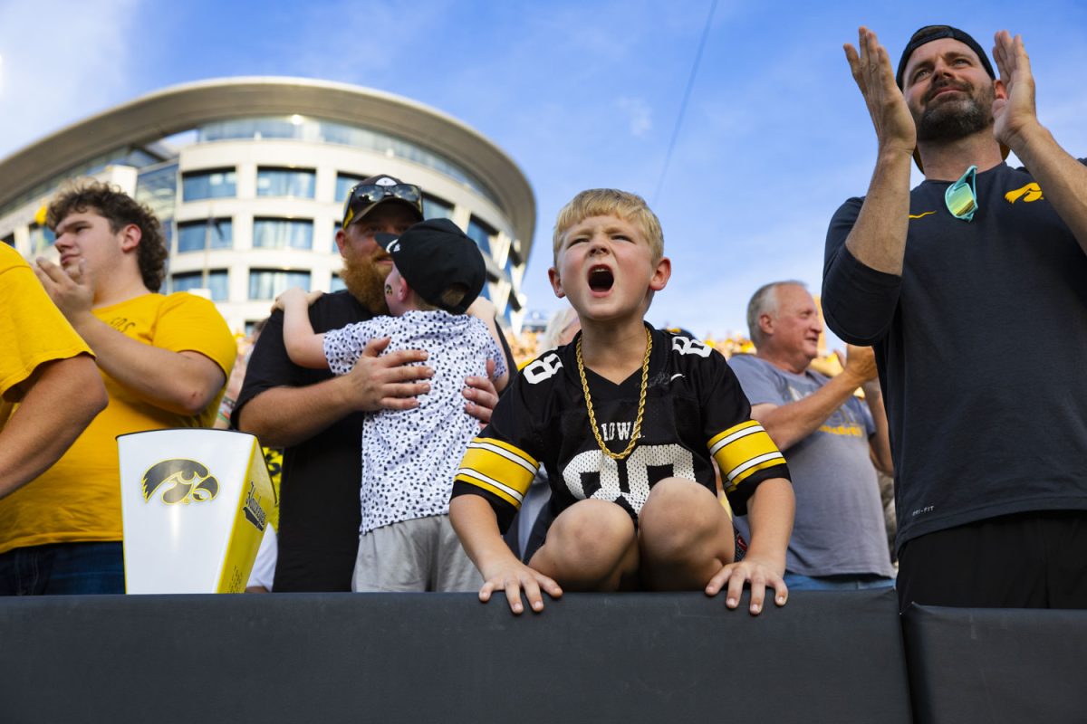 A young fan cheers during a football game between the Iowa Hawkeyes and the Albany Great Danes at Kinnick Stadium on Saturday, Aug. 30, 2025. The Hawkeyes defeated the Great Danes 34-7.