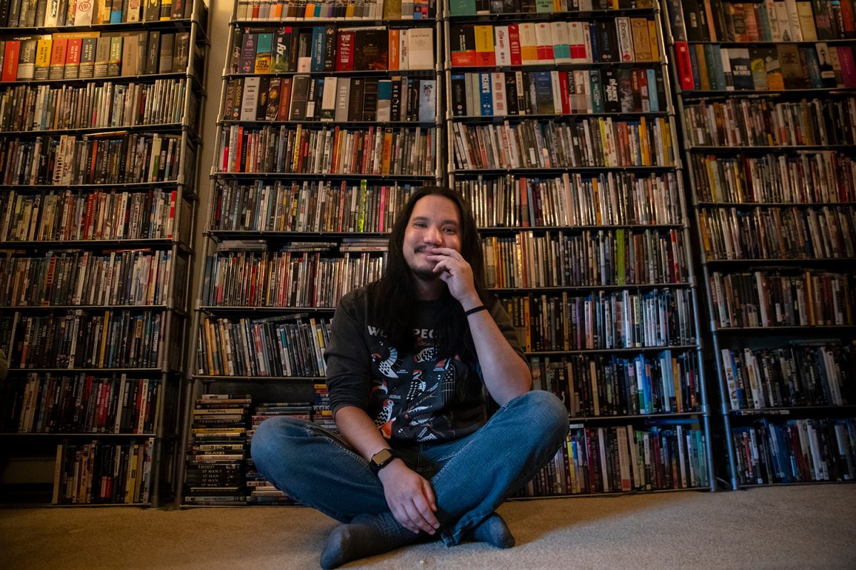 Chris Wei, a collector of physical media such as DVDs, poses for a portrait at his apartment in Iowa City on Thursday, Aug. 14, 2025. Wei has been collecting for around a decade and a half. Wei said that one of his favorite things about having his collection is that it lets him be a great host, with something to watch for everyone.