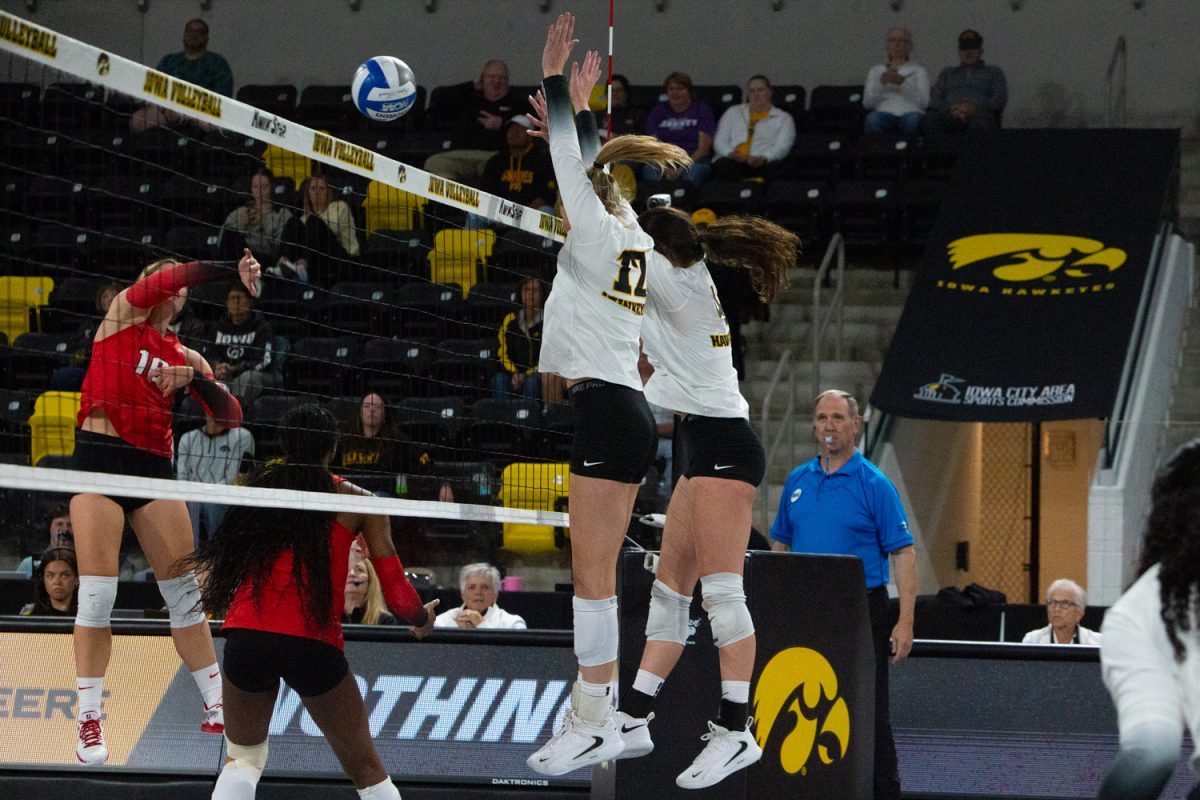 Iowa middle hitter Hannah Whittingstall and setter Claire Ammeraal attempt to block a swing from Illinois left side hitter Oliwia Caputa during a volleyball game between Iowa and Illinois State at Xtream Arena in Coralville on Friday night Sep. 5, 2025. Whittingstall earned seven kills. The Hawkeyes defeated the Redbirds 3-0.