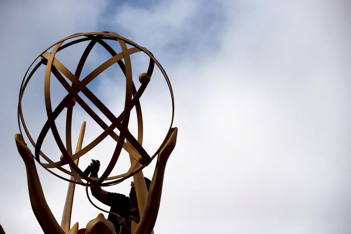 A worker touches up an Emmy statue during preparations for the 69th Emmy Awards at Microsoft Theater in Los Angeles, California, U.S., September 12, 2017. REUTERS/Mario Anzuoni