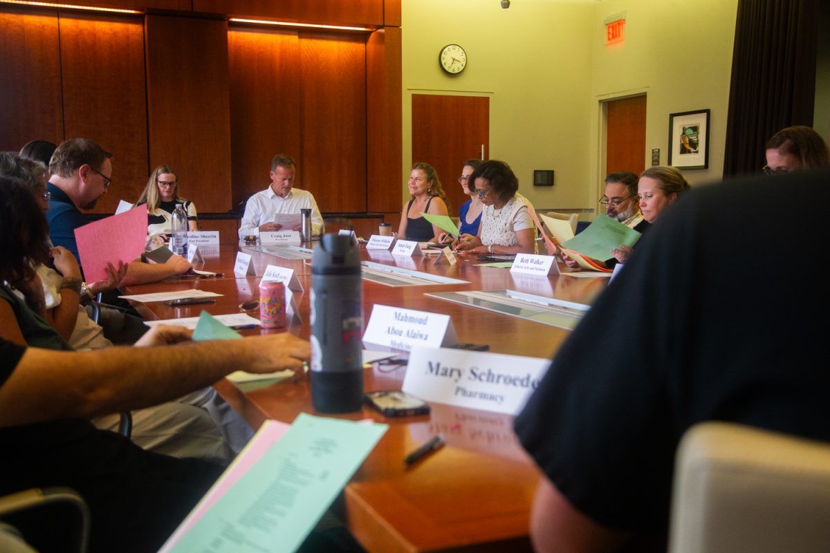 Council members look through the agenda during a faculty council meeting inside the Old Capitol Centre on Tuesday, Sep. 2, 2025.