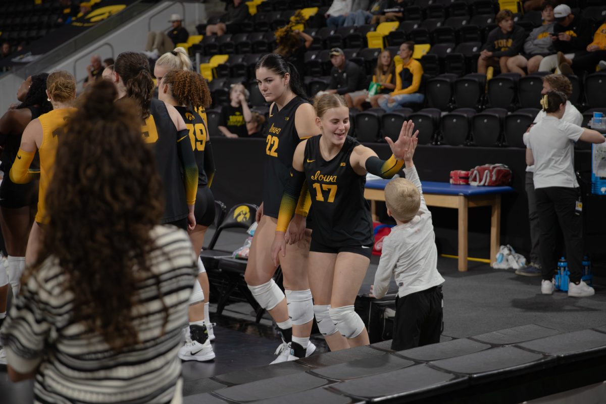 The Iowa Hawkeyes No. 17, Greta Schlichter, high-fives a fan during a game against the Butler Bulldogs. at Xtream Arena in Coralville, Iowa on Thursday, Sept. 4, 2025. Butler was the first opponent Iowa faced in the Kwik Star Klassic. The Hawkeyes defeated the Bulldogs 3-0, extending their win streak to 4-0.
