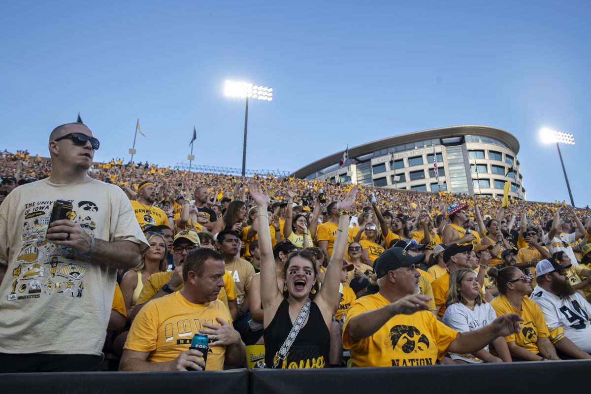 Audience members cheer during a football game between Iowa and the University of Massachusetts at Kinnick Stadium on Saturday, Sept. 13, 2025. The Hawkeyes defeated the Minutemen 47-7.