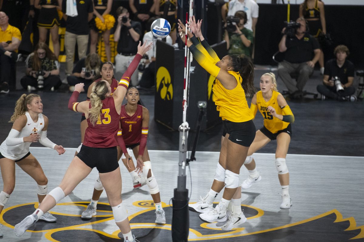 Iowa State right side hitter Lilly Wachholz attempts to tip over the Iowa block during a volleyball game between Iowa and Iowa State at Xtream Arena in Coralville on Wednesday, Sept. 17, 2025. Wachholz earned 14 kills. The Cyclones defeated the Hawkeyes 3-2.