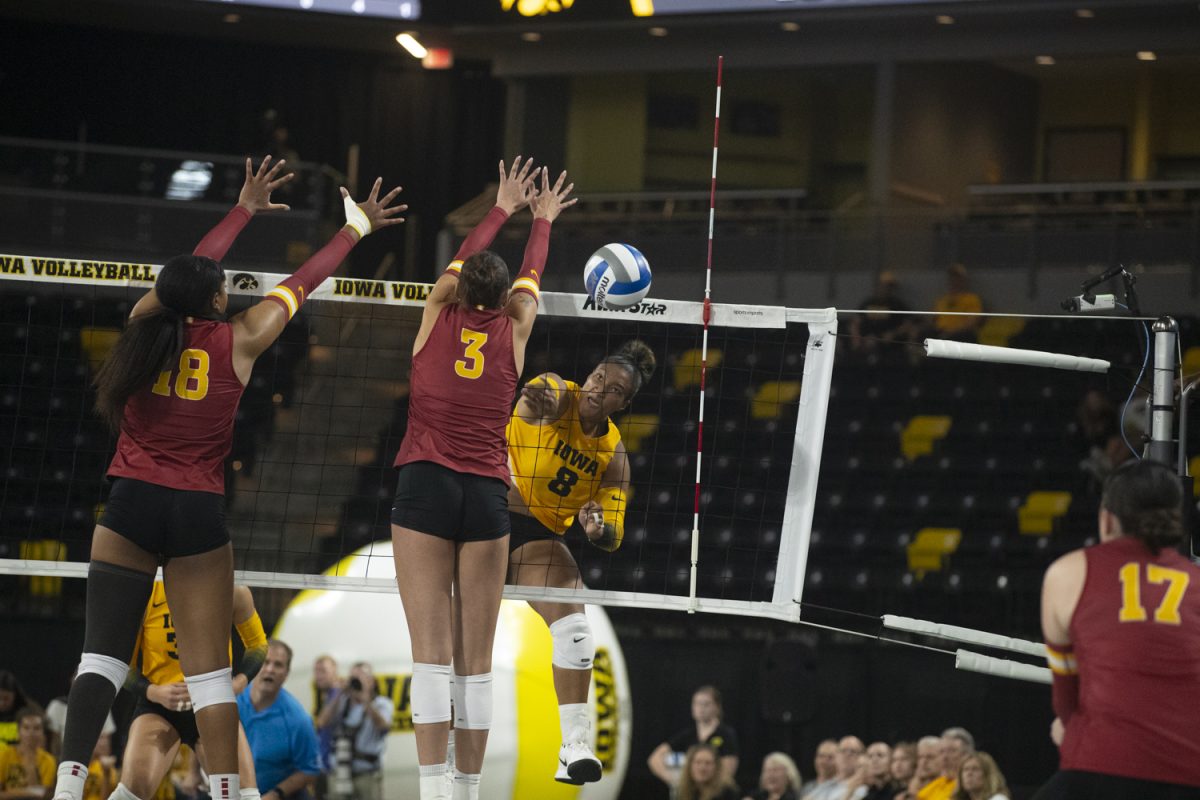 Iowa outside hitter Gia McGrew swings around the Iowa State block during a volleyball game between Iowa and Iowa State at Xtream Arena in Coralville on Wednesday, Sept. 17, 2025. McGrew earned 13 kills. The Cyclones defeated the Hawkeyes 3-2.