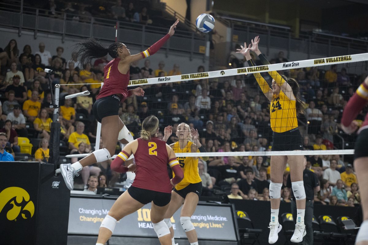 Iowa middle hitter Aleksandra Stojanovic attempts to block a hit from Iowa State middle blocker Pam McCune during a volleyball game between Iowa and Iowa State at Xtream Arena in Coralville on Wednesday, Sept. 17, 2025. McCune earned nine kills. The Cyclones defeated the Hawkeyes 3-2.