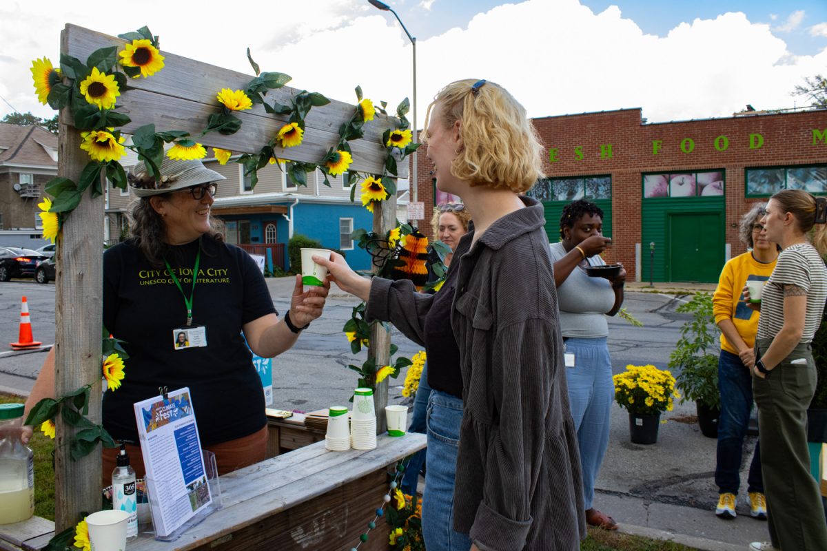 Sarah Gardner hands out lemonade during the Climate Festival Pocket Park Celebration at the corner of Washington St. and Van Buren St. in Iowa City on Friday, Sept. 19, 2025. Organizers gave out lemonade and a prize to anyone to biked or walked instead of drove to work during National Parking Day. Yard games and houseplants donated by City Council members decorated the Pop-Up event.