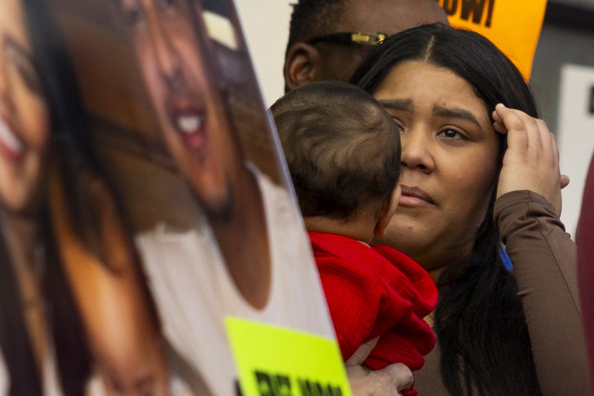 Laura Castro, partner of Jorge Elieser Gonzlez Ochoa holds back tears during a rally at the Pedestrian Mall in Iowa City, Iowa on Friday, Sep. 26, 2025. Community members gathered in protest against ICE’s arrest of  González Ochoa while working at Bread Garden in Iowa City on Thursday, Sept. 25 at 11:00 a.m. Jorge’s family members, clergy, and elected leaders spoke at the rally.