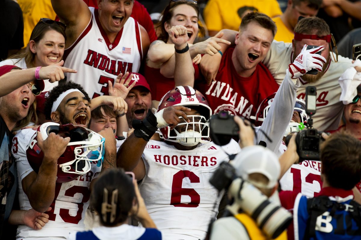 Indiana wide receiver Elijah. Sarratt, Indiana wide receiver Lebron Bond, and Indiana defensive lineman Kellan Wyatt celebrate with fans after winning a BIG10 matchup between the No. 11 Indiana Hoosiers and the Iowa Hawkeyes at Kinnick Stadium in Iowa City on Saturday, Sept. 27, 2025. The Hoosiers defeated the Hawkeyes 20-15.