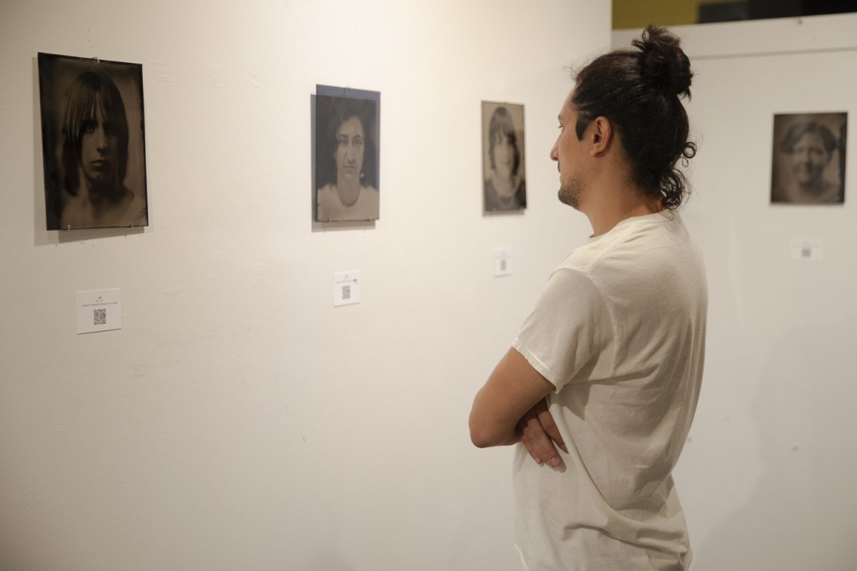 Ramin Roshandel, the creator of the exhibit, looks over his work at ArtiFactory in Iowa City, Iowa on Friday, Sept. 12, 2025. Ramin began this project in March 2025, reaching out to transgender people in Iowa to tell their story.
