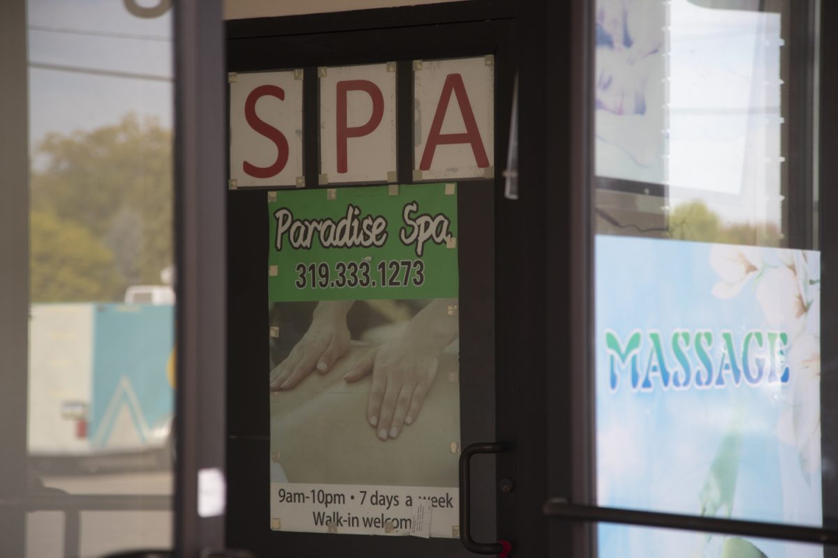 A poster displaying business information is seen outside of Paradise Spa on Oct. 1, 2025. This is one of the two locations that exist in Iowa City.