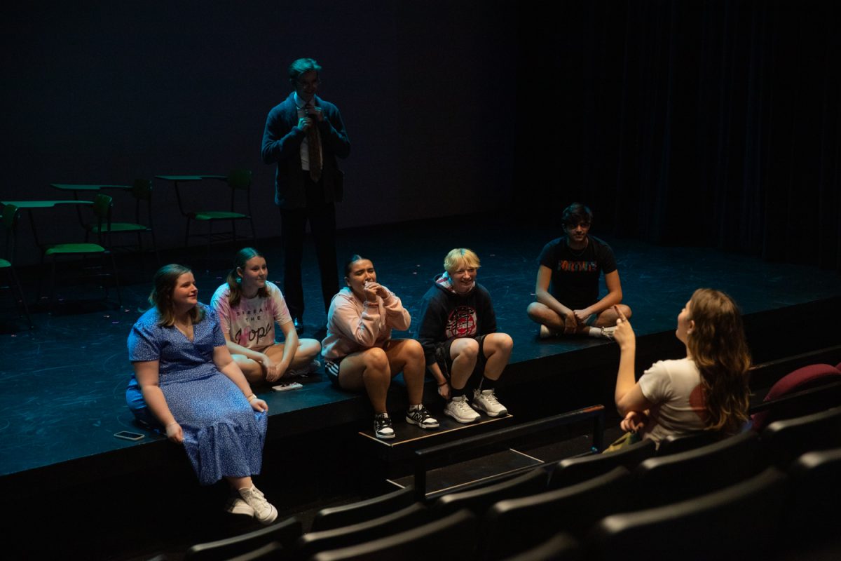 The cast of the University of Iowa theatre production “Drill, Drill, Drill” performs a dress rehearsal on Thursday, Oct. 16, 2025, at the Alan MacVey Theatre in Iowa City. The production depicts teens growing up in a world with mass shooters and mass shooter drills in schools.