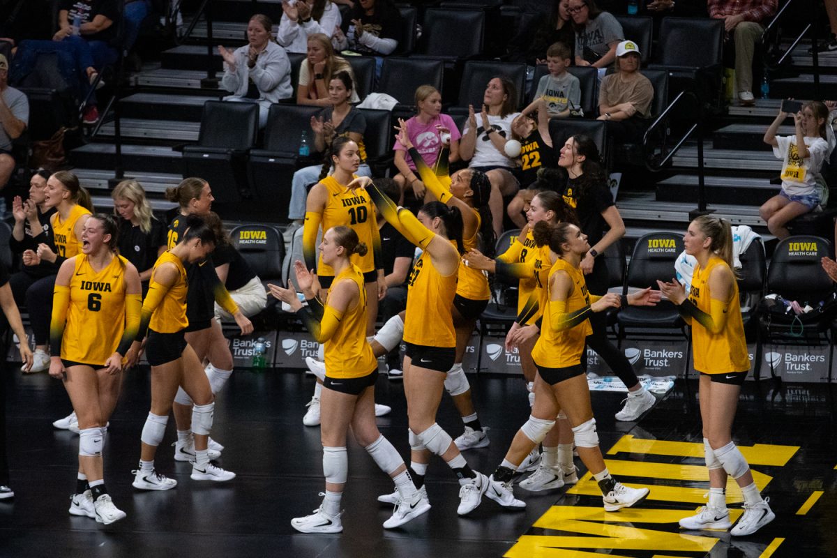 Iowa’s bench celebrating a setter dump during the volleyball game against No. 25 USC at Carver-Hawkeye Arena in Iowa City on Friday, Oct. 17, 2025. The Hawkeyes lose to the No. 25 Trojans 3-1 in heated overtime.