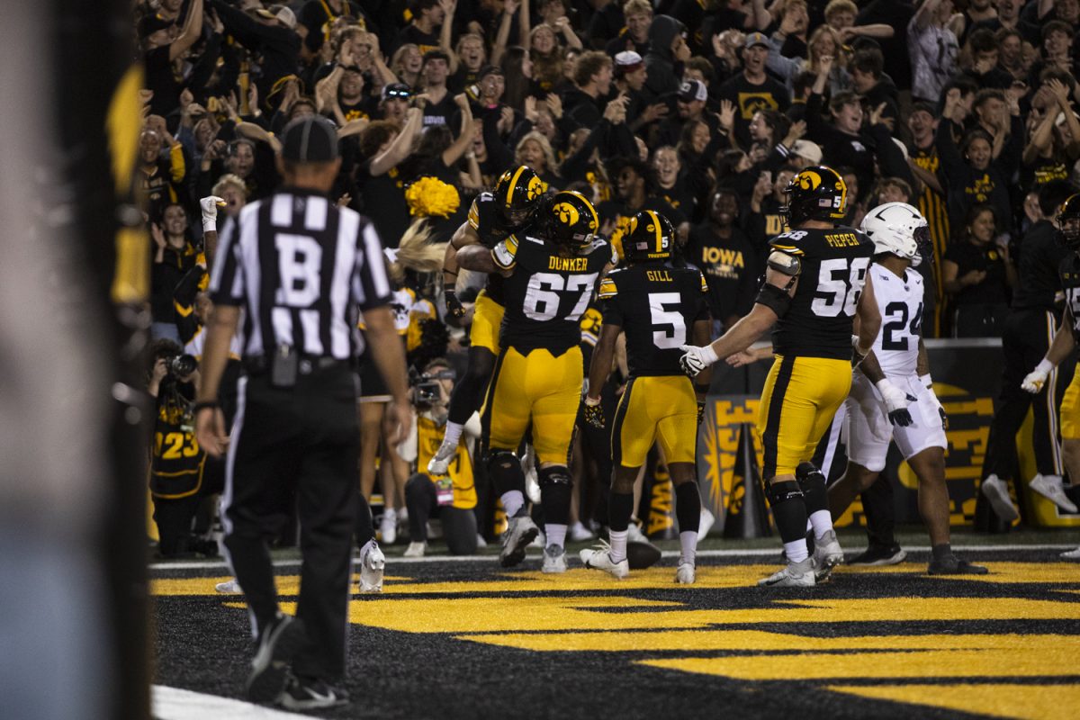 Iowa offensive lineman Gennings Dunker picks up wide receiver Kaden Wetjen during an Iowa football game against Penn State on Saturday, Oct. 18, 2025 at Kinnick Stadium in Iowa City, Iowa. The Hawkeyes beat the Nittany Lions 25-24.