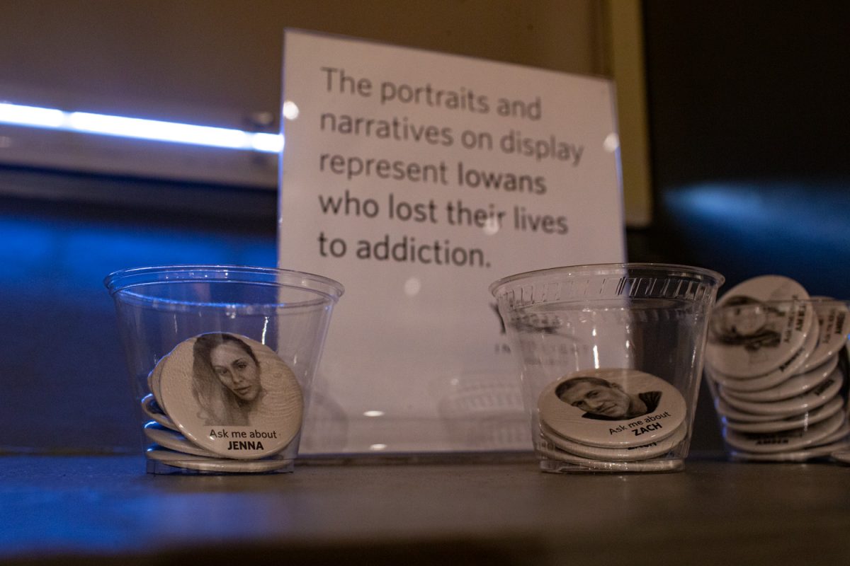 The Into Light Project is seen at the Old Capitol Museum on Thursday, Oct. 23, 2025. The exhibit Drug Addiction: Real People, Real Stories features illustrations of over 30 individuals who have lost their lives to drug addiction. Pins are also available to spark conversation about their mission.