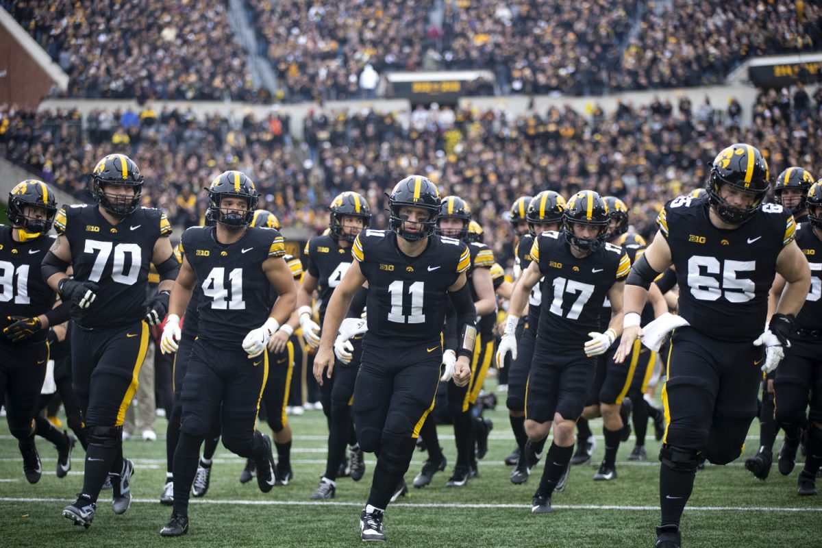 Iowa quarterback Mark Gronowski runs onto the field with the team during an Iowa football game against the University of Minnesota at Kinnick Stadium in Iowa City, Iowa on Oct. 25, 2025. Gronowski had one touchdown. The Hawkeyes defeated the Golden Gophers 41-3.