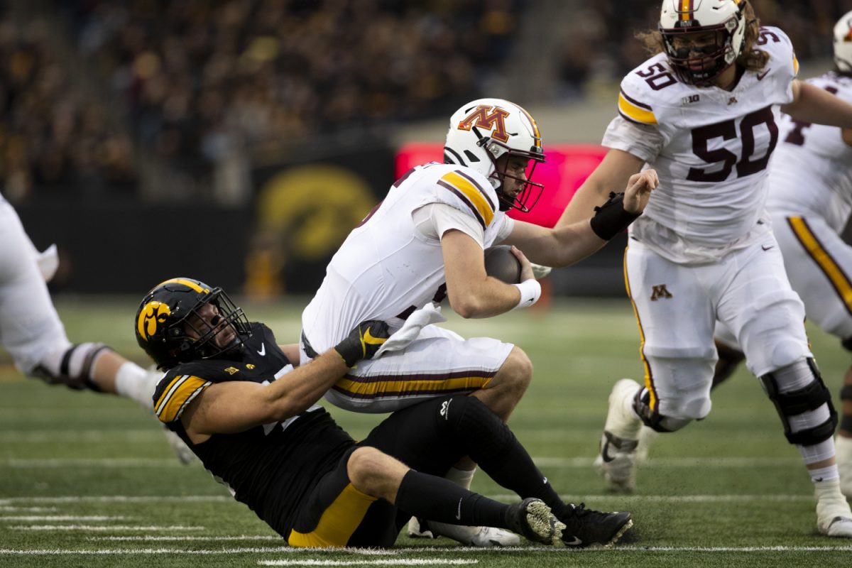 Iowa defensive lineman Ethan Hurkett sacks Minnesota quarterback Drake Lindsey during an Iowa football game against the University of Minnesota at Kinnick Stadium in Iowa City, Iowa on Oct. 25, 2025. Hurkett had one sack. The Hawkeyes defeated the Golden Gophers 41-3.