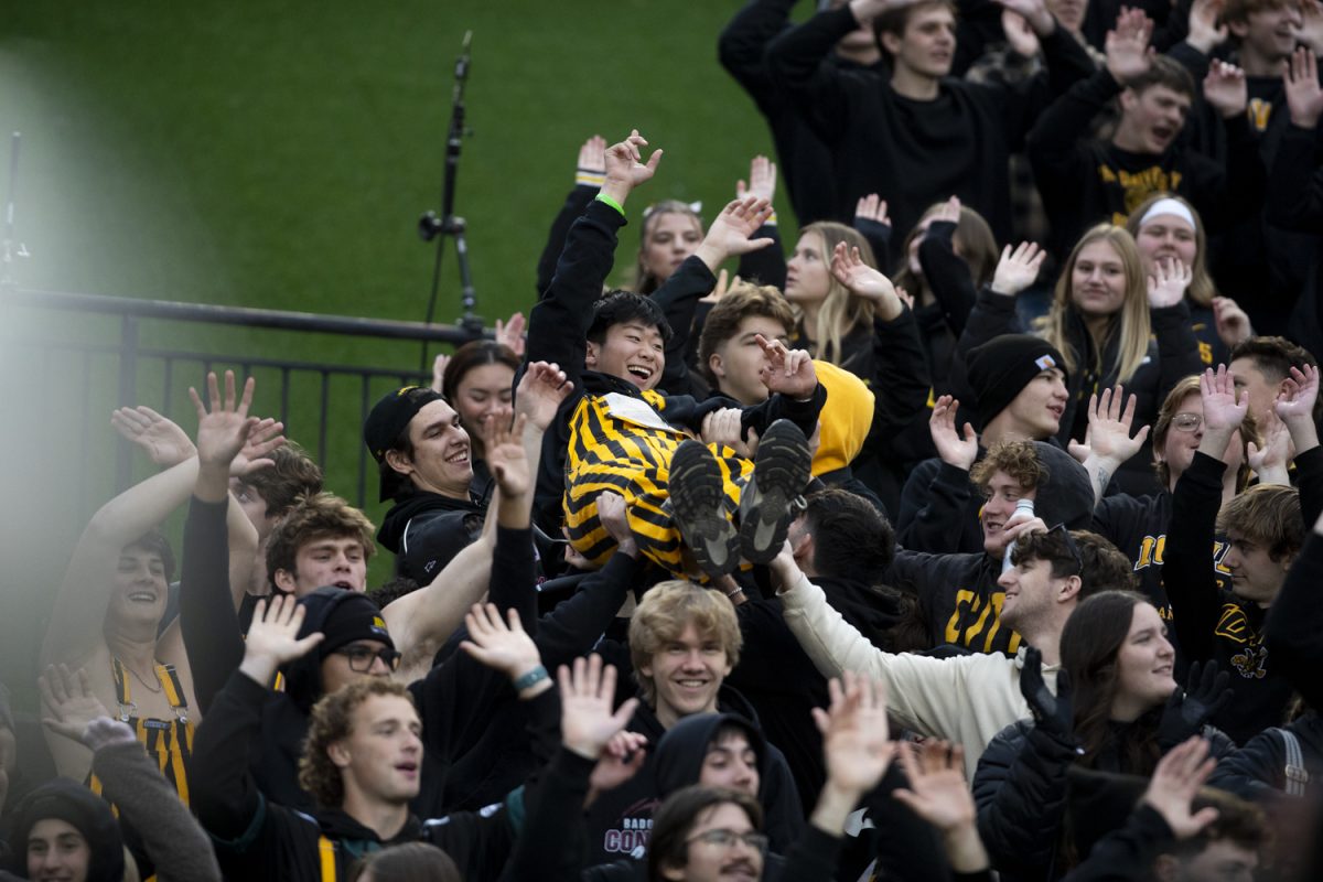 A fan is thrown up in the air by others during an Iowa football game against the University of Minnesota at Kinnick Stadium in Iowa City, Iowa on Oct. 25, 2025. The Hawkeyes defeated the Golden Gophers 41-3.