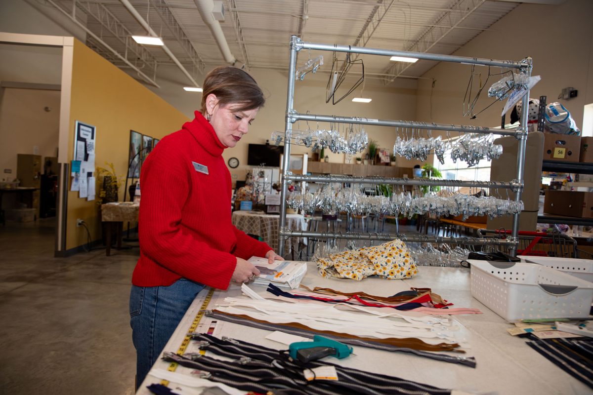 Amy Hospodarsky organizes the storeroom at Crowded Closet in Iowa City on Monday, Oct. 27, 2025. Hospodarsky is running from Iowa City Council this upcoming election, and has worked as director at the Crowded Closet for the past year because “It’s a mesh of all the causes I’m interested in.”