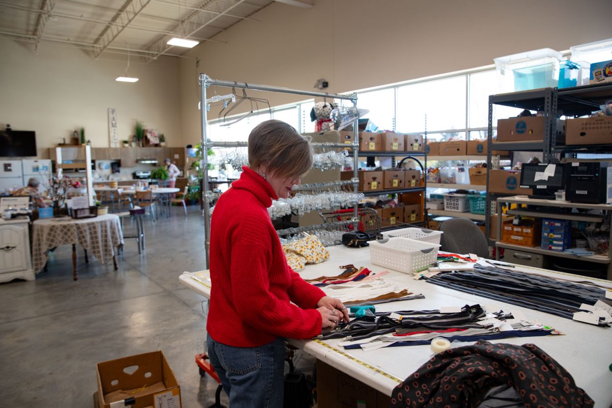 Amy Hospodarsky organizes the storeroom at Crowded Closet in Iowa City on Monday, Oct. 27, 2025. Hospodarsky is running from Iowa City Council this upcoming election, and has worked as director at the Crowded Closet for the past year because “It’s a mesh of all the causes I’m interested in.”