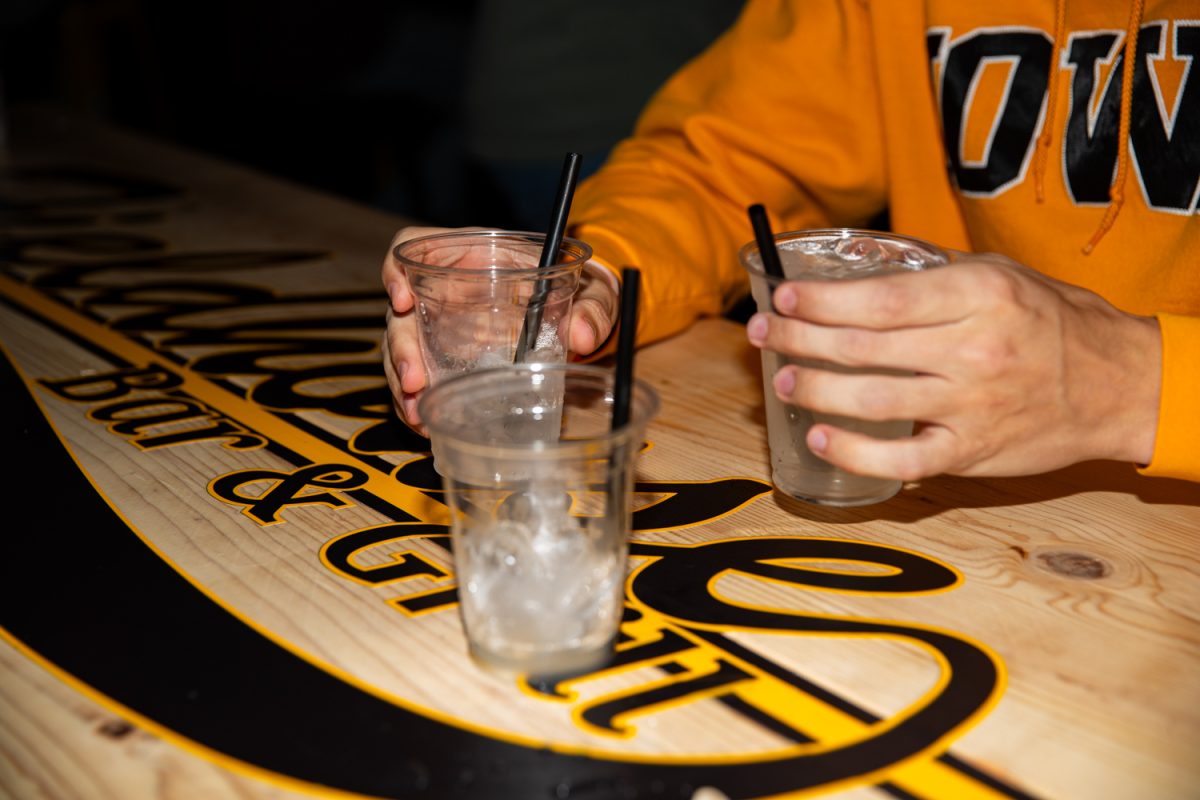 Patrons drink during the opening night of Fieldhouse Bar and Grill in Iowa City on Thursday, Nov. 6, 2025. Over 100 attendees lined up down the block to drink, play arcade games, and explore the new bar’s five floors. The previous Fieldhouse was located in the Pedestrian Mall, and relocated over the summer.