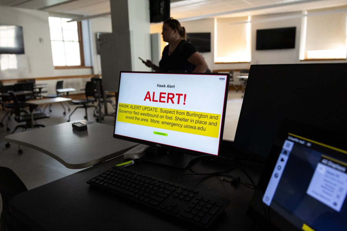 Big Noon Kickoff Media Availability attendees shelter in place after an active shooter Hawk Alert on Friday, Nov. 7, 2025 in Iowa City, Iowa.