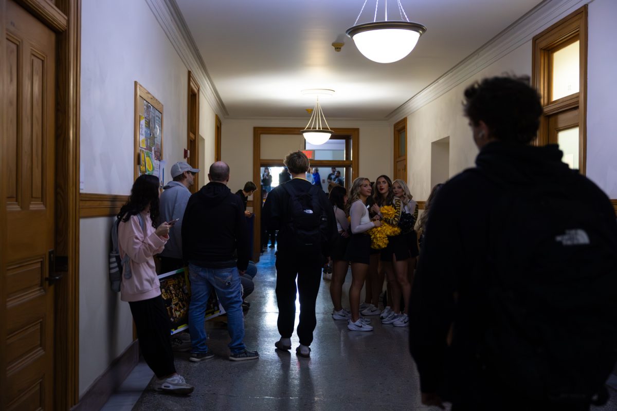 Big Noon Kickoff Media Availability attendees shelter in place after an active shooter Hawk Alert on Friday, Nov. 7, 2025 in Iowa City, Iowa.