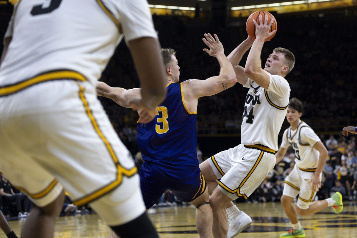 Iowa guard Bennett Stirtz goes to shoot past Western Illinois guard Lucas Lorenzen during an Iowa men’s basketball game against Western Illinois on Friday, Nov. 7, 2025 at Carver-Hawkeye Arena in Iowa City, Iowa. Stirtz played all 40 minutes of the game. The Hawkeyes defeated the Leathernecks 77-58.