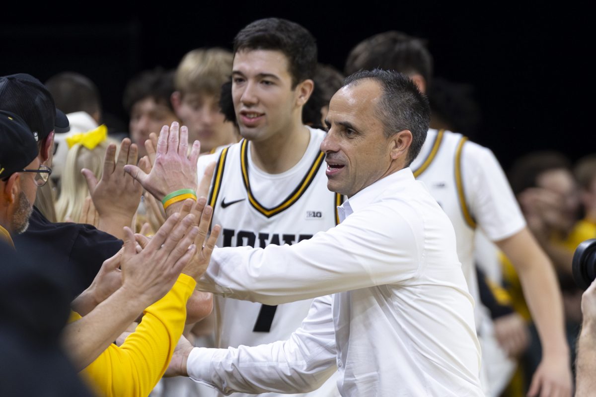 Iowa head coach Ben McCollum and the players high five fans during an Iowa men’s basketball game against Western Illinois on Friday, Nov. 7, 2025 at Carver-Hawkeye Arena in Iowa City, Iowa. This is McCollum's first year as head coach with Iowa. The Hawkeyes defeated the Leathernecks 77-58.