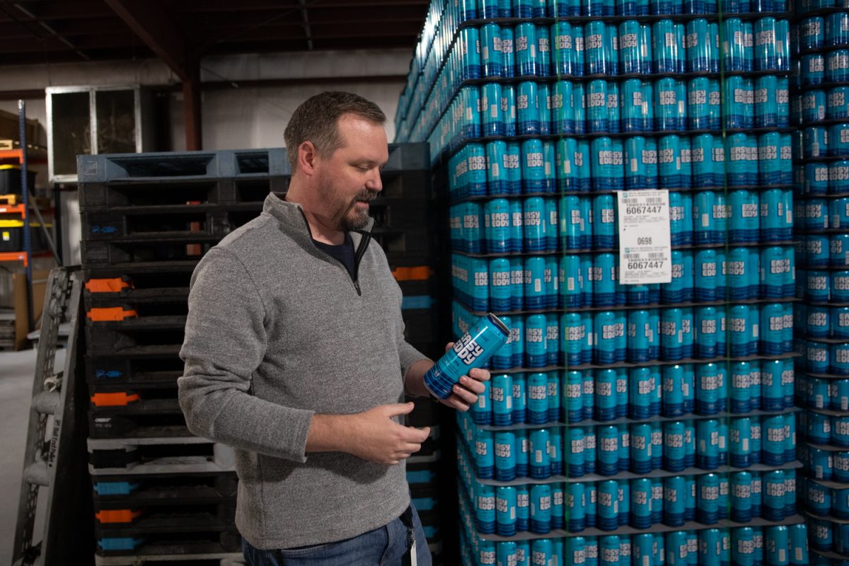 Will Farmer, the production and forecast analyst at Big Grove Brewery, holds an empty Easy Eddy can at the Big Grove distilery in Iowa City, Iowa, on Nov. 11, 2025. Easy Eddy is Big Grove Brewery’s top selling beer and though the cans are manufactured in the U.S. the aluminum used to make the cans is rising in price.