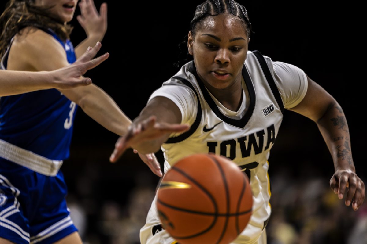 Freshman guard Journey Houston reaches to save knocked out ball during an in-state rivalry basketball game between the Iowa Hawkeyes and the Drake Bulldogs at Carver Hawkeye Arena in Iowa City, Iowa on Thursday, Nov. 13, 2025. The Hawkeyes defeated the Drake Bulldogs 100-58. Houston had six rebounds and four total points in her fourteen minutes of play. Houston was a four star prospect from Davenport North High School.