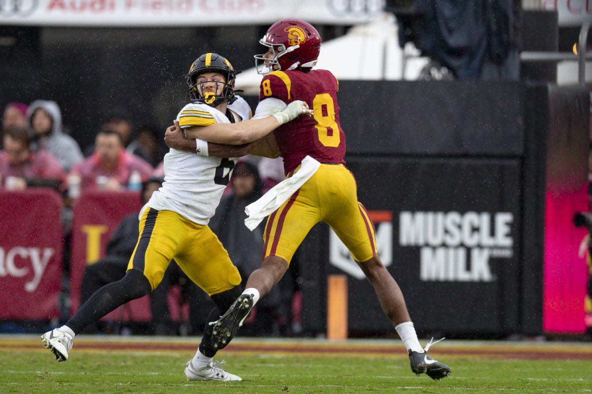 Iowa defensive back Zach Lutmer blocks Southern California wide receiver Ja'Kobi Lane during a football game between the Iowa Hawkeyes and the USC Trojans at Los Angeles Memorial Coliseum in Los Angeles, Calif., on Saturday, Nov. 15, 2025. The Trojans defeated the Hawkeyes 26-21.