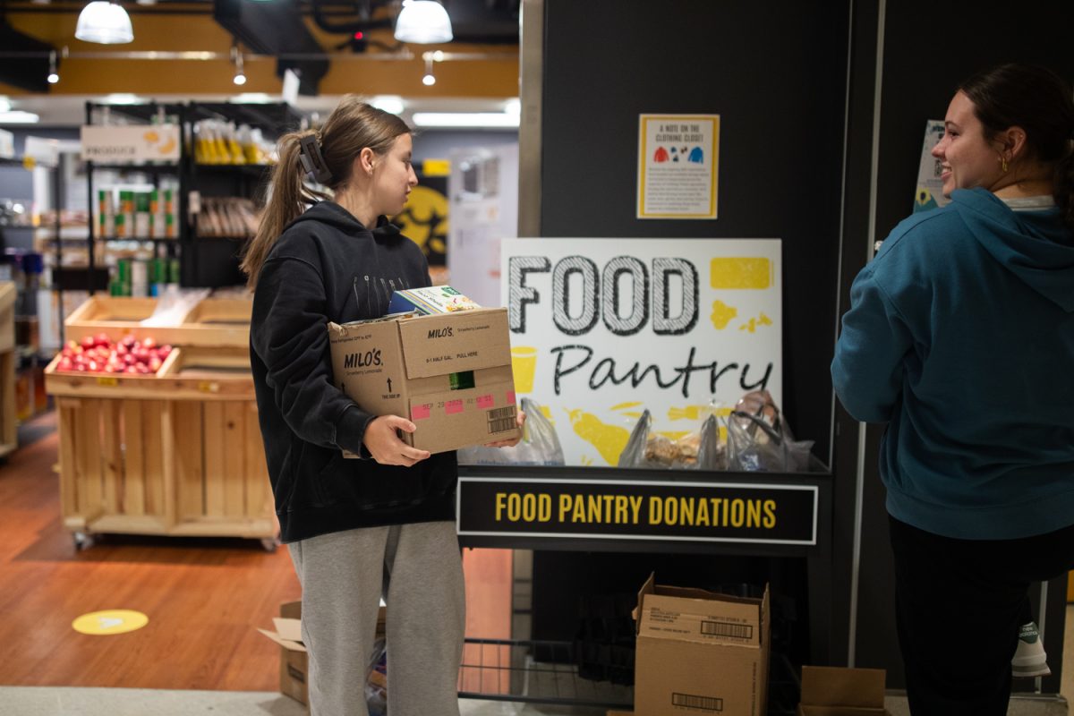 Student workers manage donations for Rivals for Hunger on Monday, Nov. 17, 2025 at the Iowa Memorial Union. Rivals for Hunger is a competition between Iowa universities to see who can donate the most food items, beginning Nov. 17, 2025, and lasting until Friday, Dec. 5, 2025. The Iowa Food Pantry is managing the donation, and had already received around 130 donations by noon, received mostly from Iowa professors and students.
