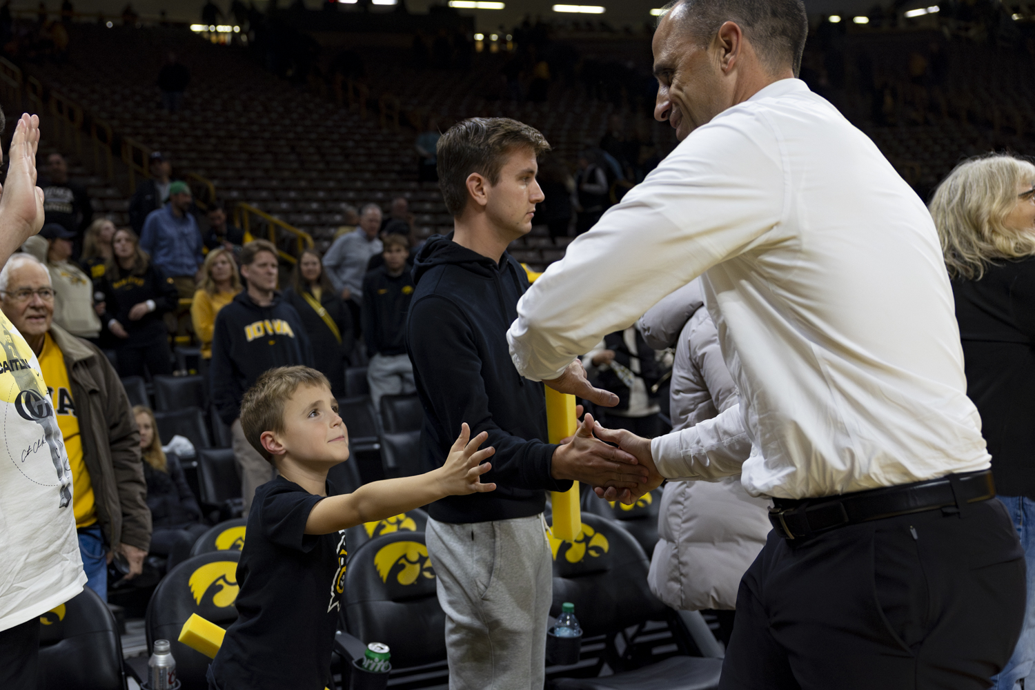 Iowa head coach Ben McCollum high fives a young fan after a basketball game between the Iowa Hawkeyes and the Southeast Missouri State Redhawks at Carver-Hawkeye Arena on Thursday, Nov. 18, 2025. This is McCollum's first year with Iowa. The Hawkeyes defeated the Redhawks 99-70.
